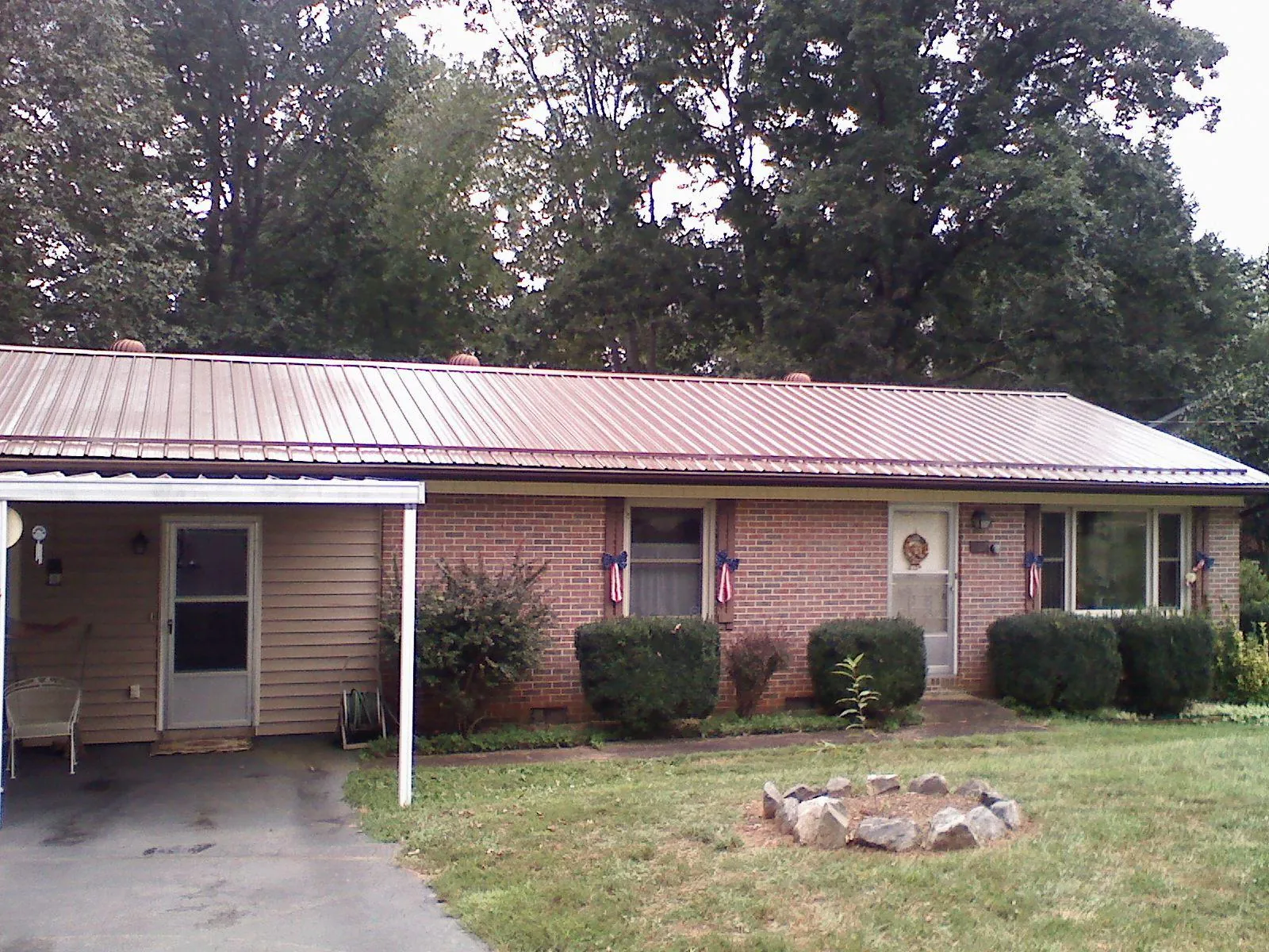 Bronze metal roof and carport on a brick ranch home — Roof Repair work by our crew in Moscow